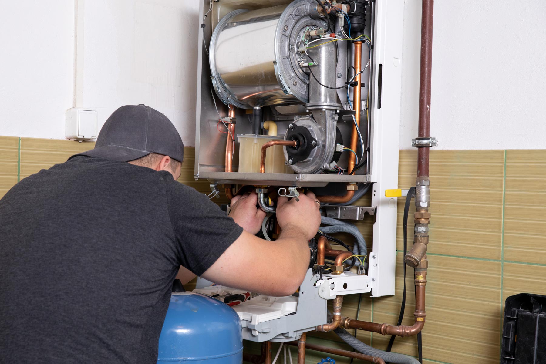 heating-services--boilers - Mountain Air Mechanical A technician working on a boiler unit.